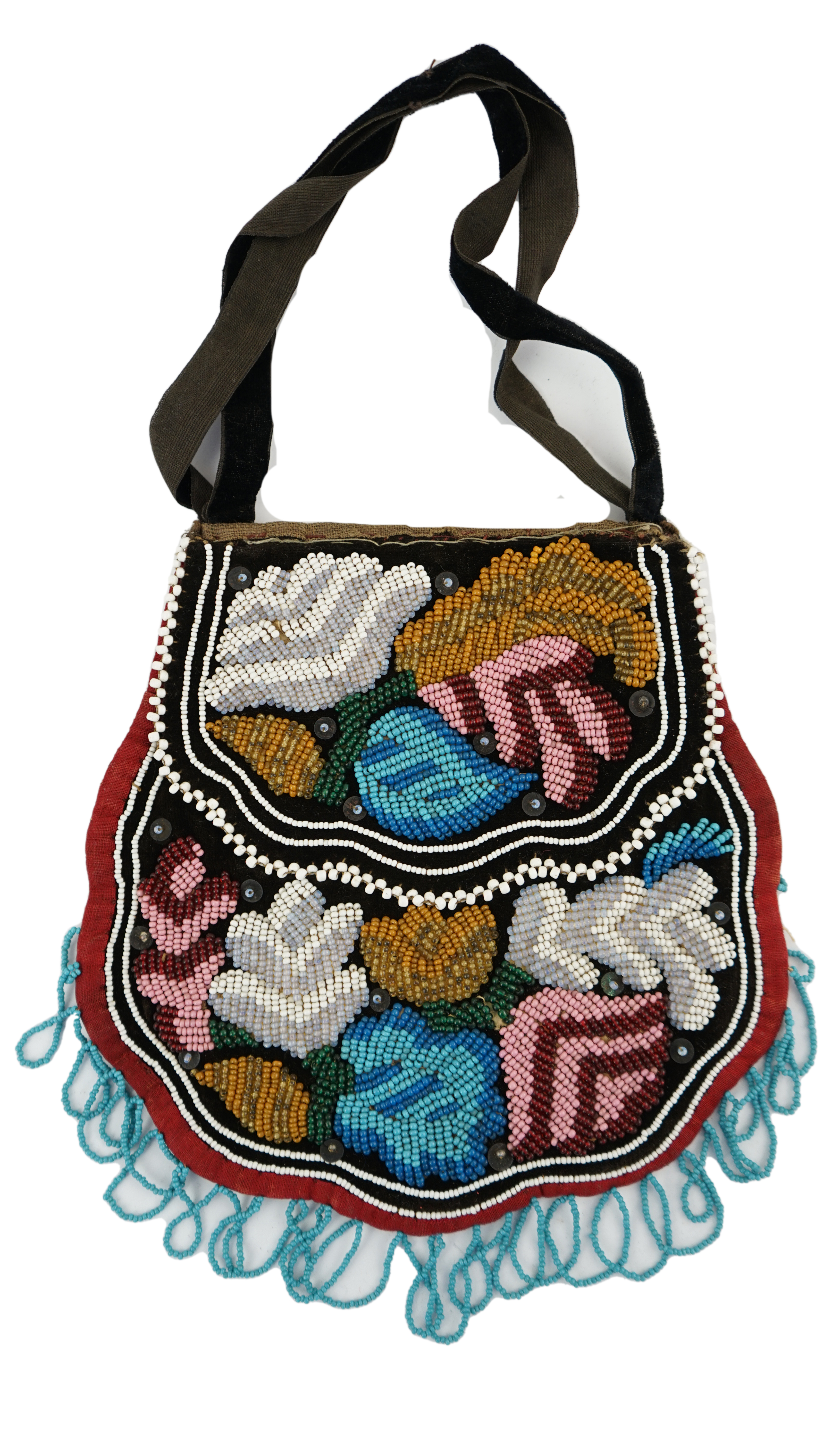 A 19th century Iroquois Native American beaded bag worked in a tightly grouped pattern of multi-coloured beads, with flaps either side and small white bead borders, fringed a similar turquoise beads. 16cm high. Condition